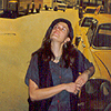 On a street in front of a wall mural of a street